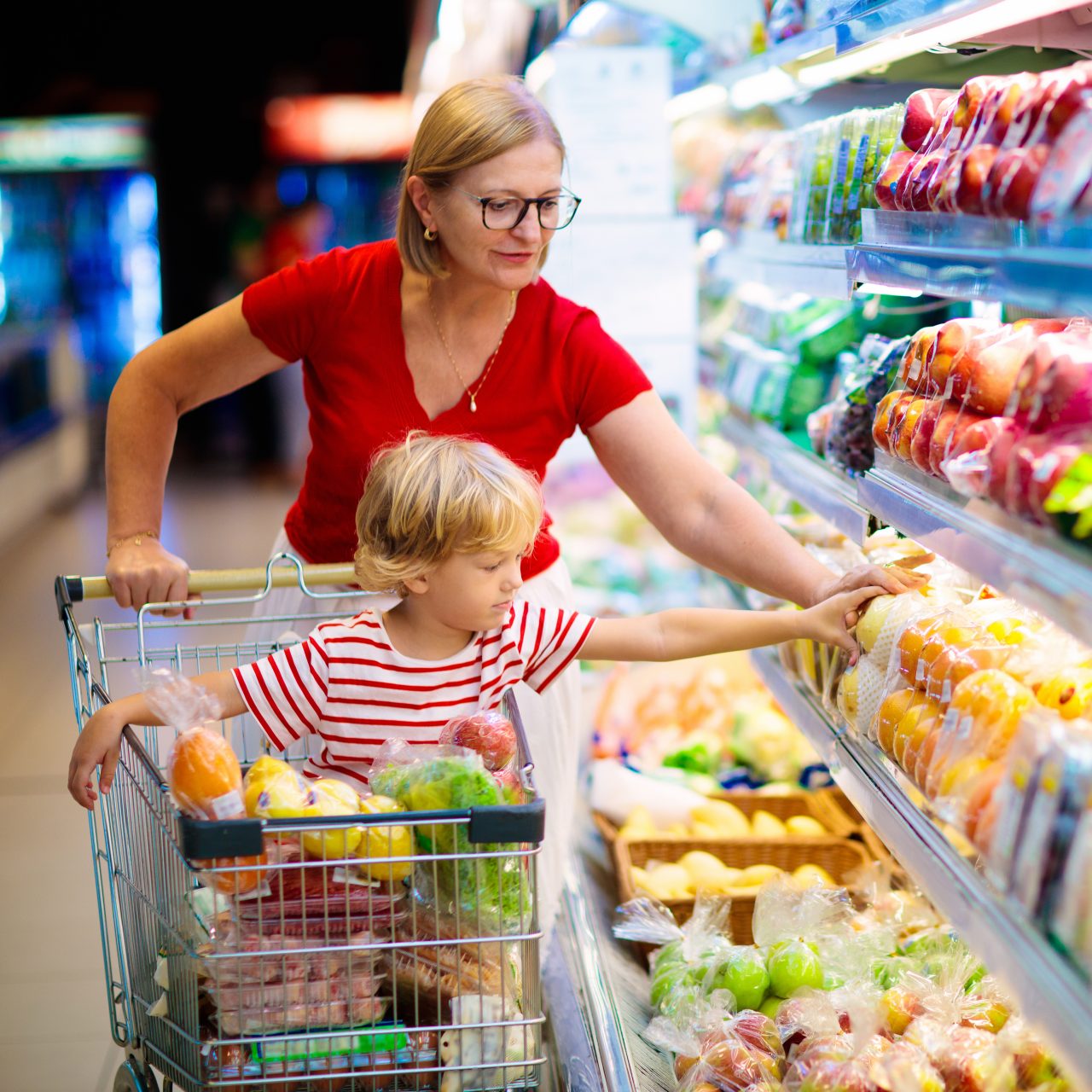 Mother and child buying sustainably packaged healthy food in a supermarket
